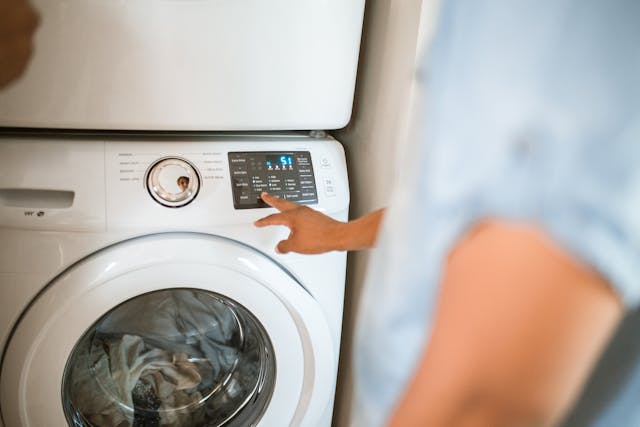 Person starting a washing machine